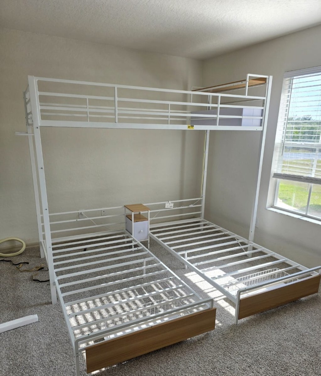 Triple bunk bed assembled in a vacation rental bedroom