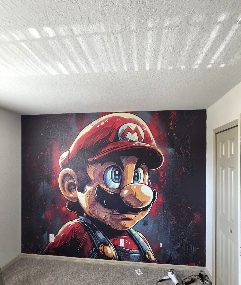 Hand-painted Super Mario mural covering a bedroom wall in a vacation rental